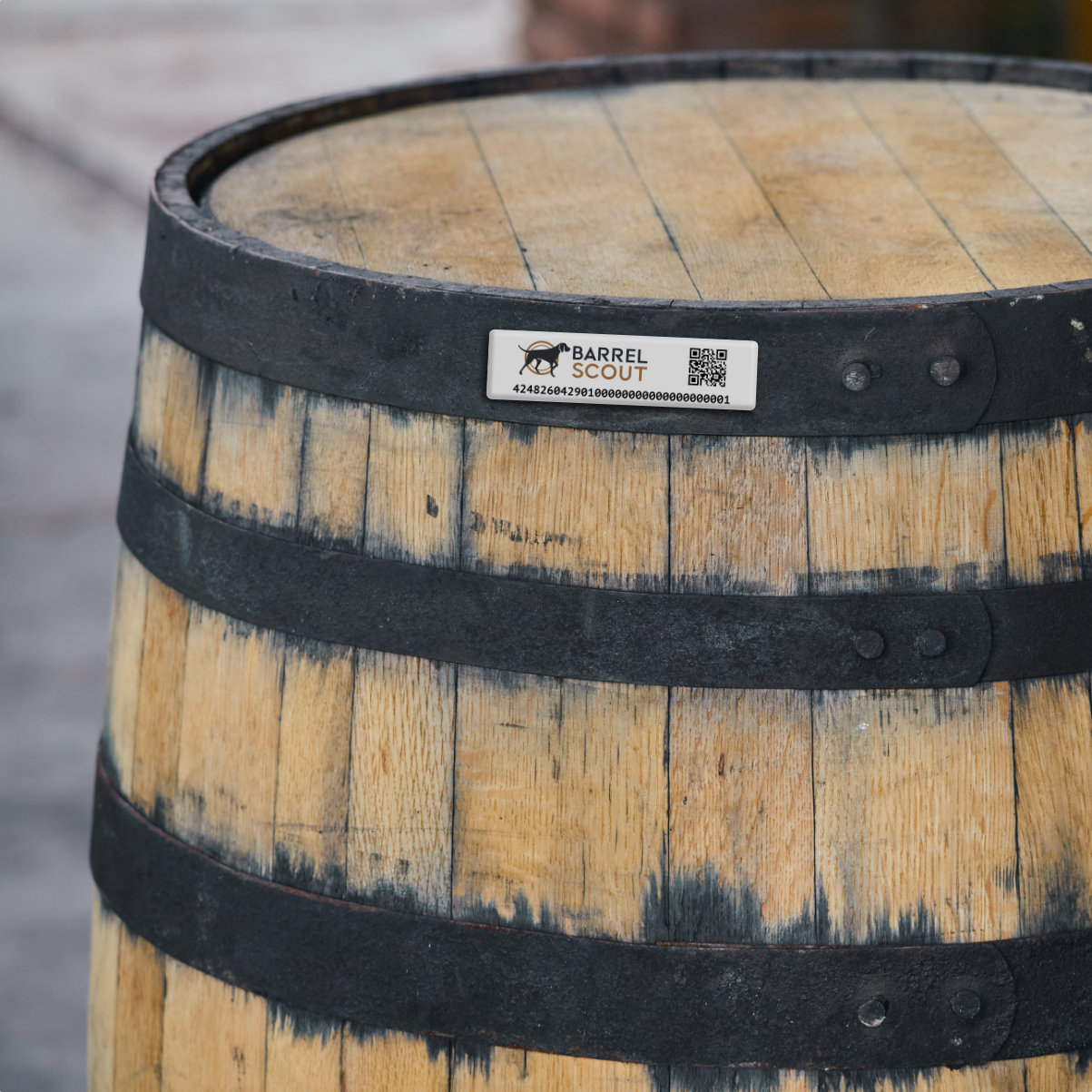 Metal hoop tag installed on the upper hoop of a bourbon barrel