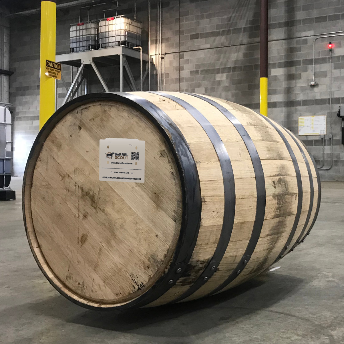 Paper barrel-head tag stapled to the head of a bourbon barrel